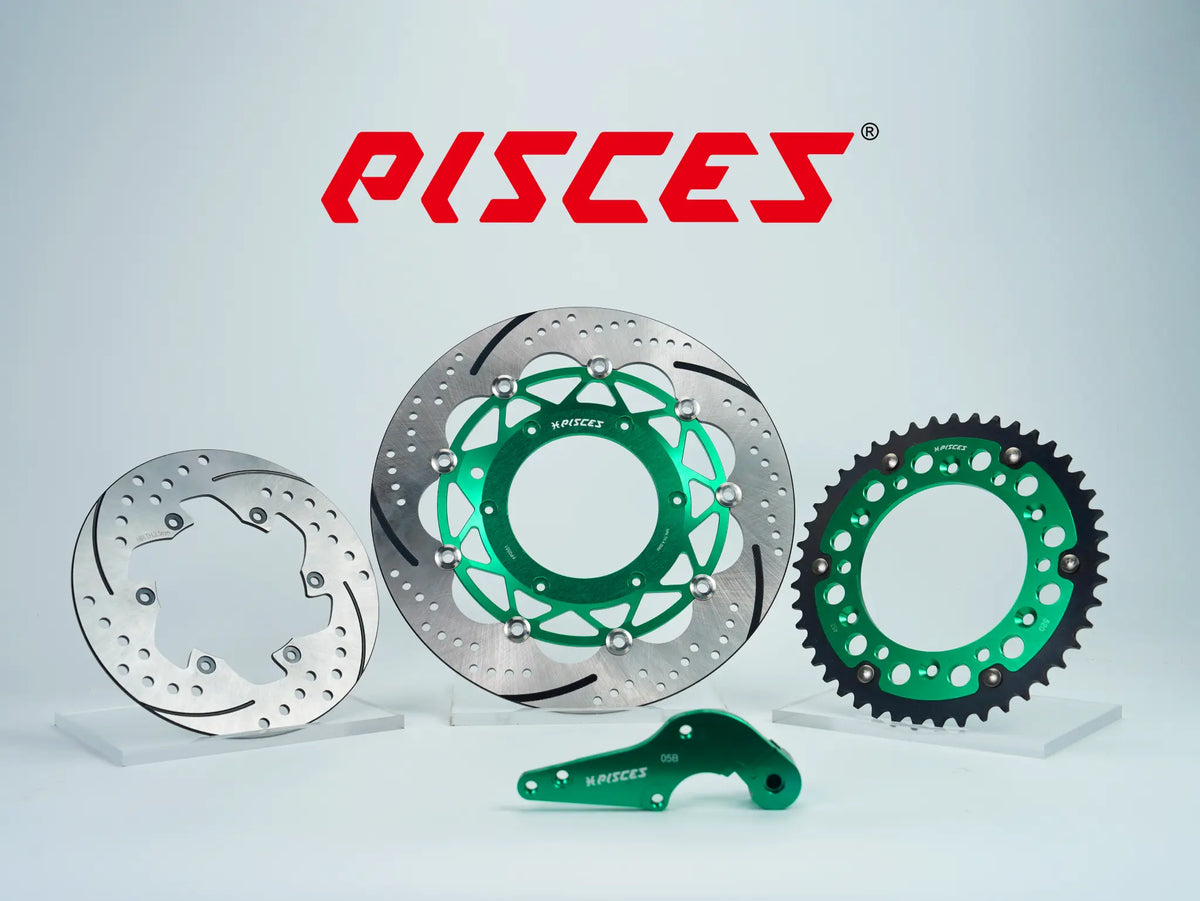 Pisces custom supermoto brake kit 320mm in green, including green front brake disc, silver rear brake disc, green sprocket and green offset bracket.